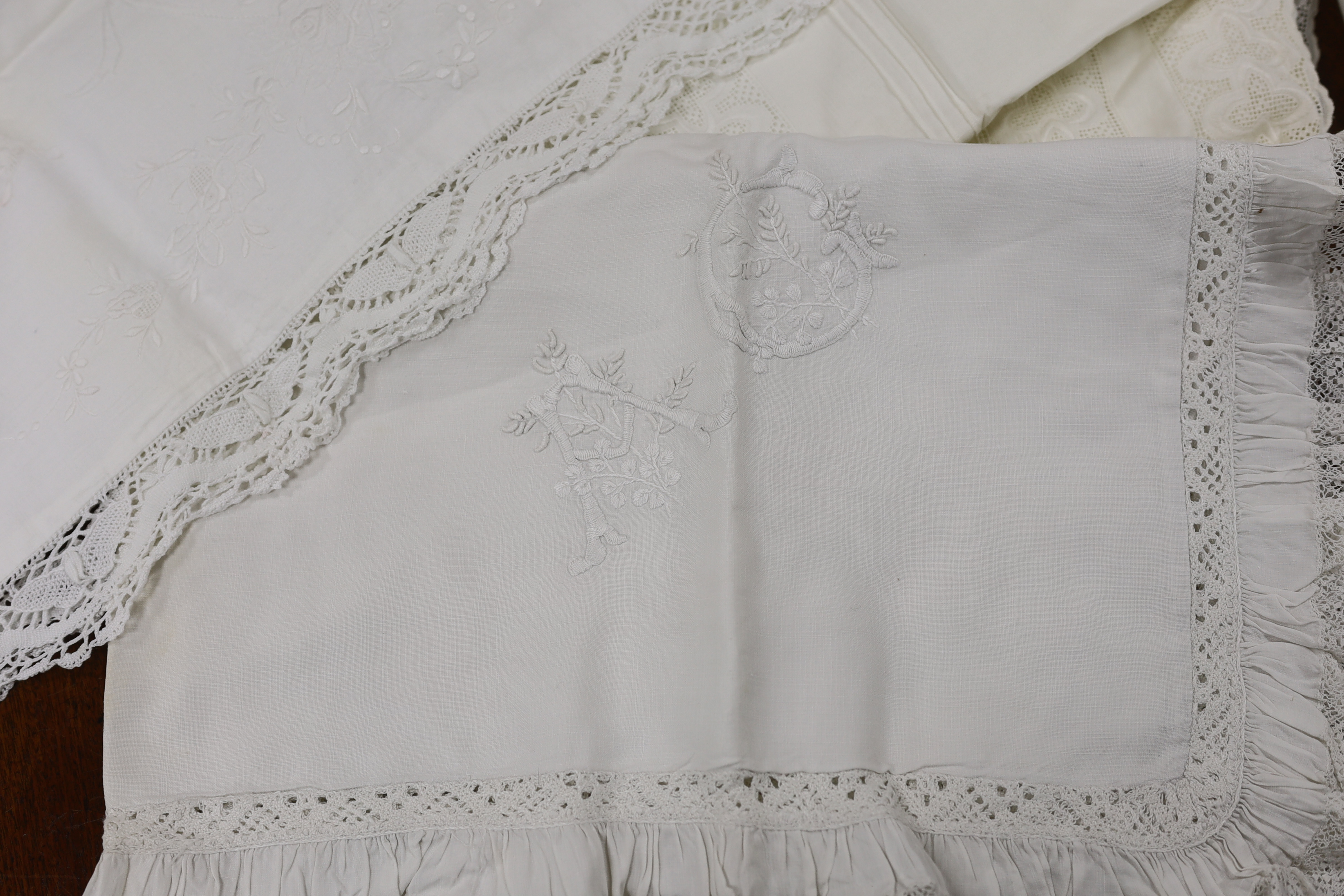 19th-20th century bed linen; a monogrammed sheet, 7ft 6in., and a smaller crochet edged sheet, a pair of French square Anglaise pillow cases, three similar appliqué pillow cases, a frilled single square pillow case and a